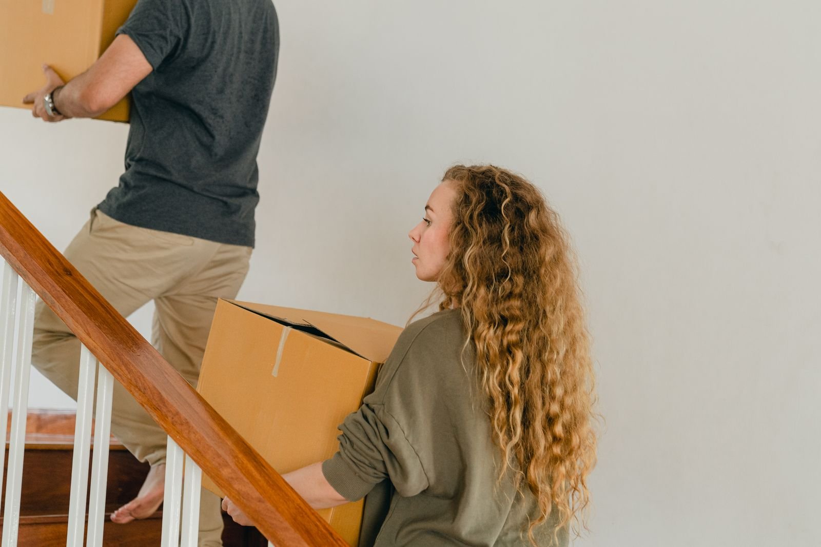 Young adults moving boxes into an apartment